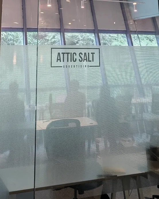 The Attic Salt Advertising studio in Powai, Mumbai — etched logo on the meeting room glass